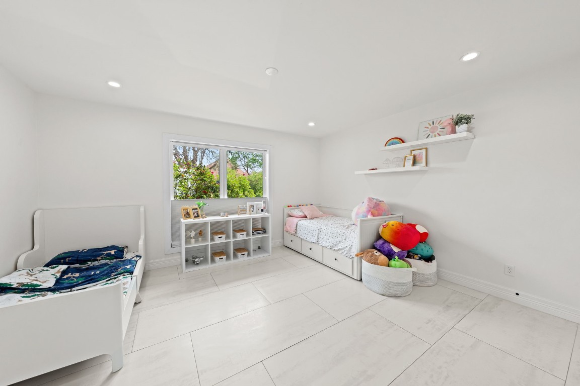 8800 Brae Acres Road Houston, TX 77074 - Photo 48 of 48 This wide secondary bedroom floorplan is open and spacious enough to create two distinctive sleeping areas.