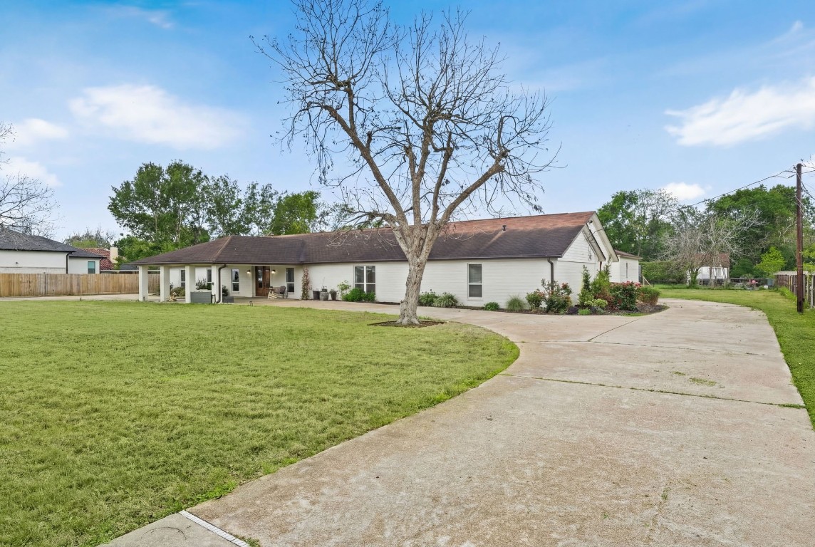 8800 Brae Acres Road Houston, TX 77074 - Photo 2 of 48 The double-wide driveway runs the full width of the front elevation, with surface for multiple vehicles ahead of the covered entry. The open front lawn and depth of the setback make the lot's scale immediately apparent as soon as you enter through the automatic driveway gate.