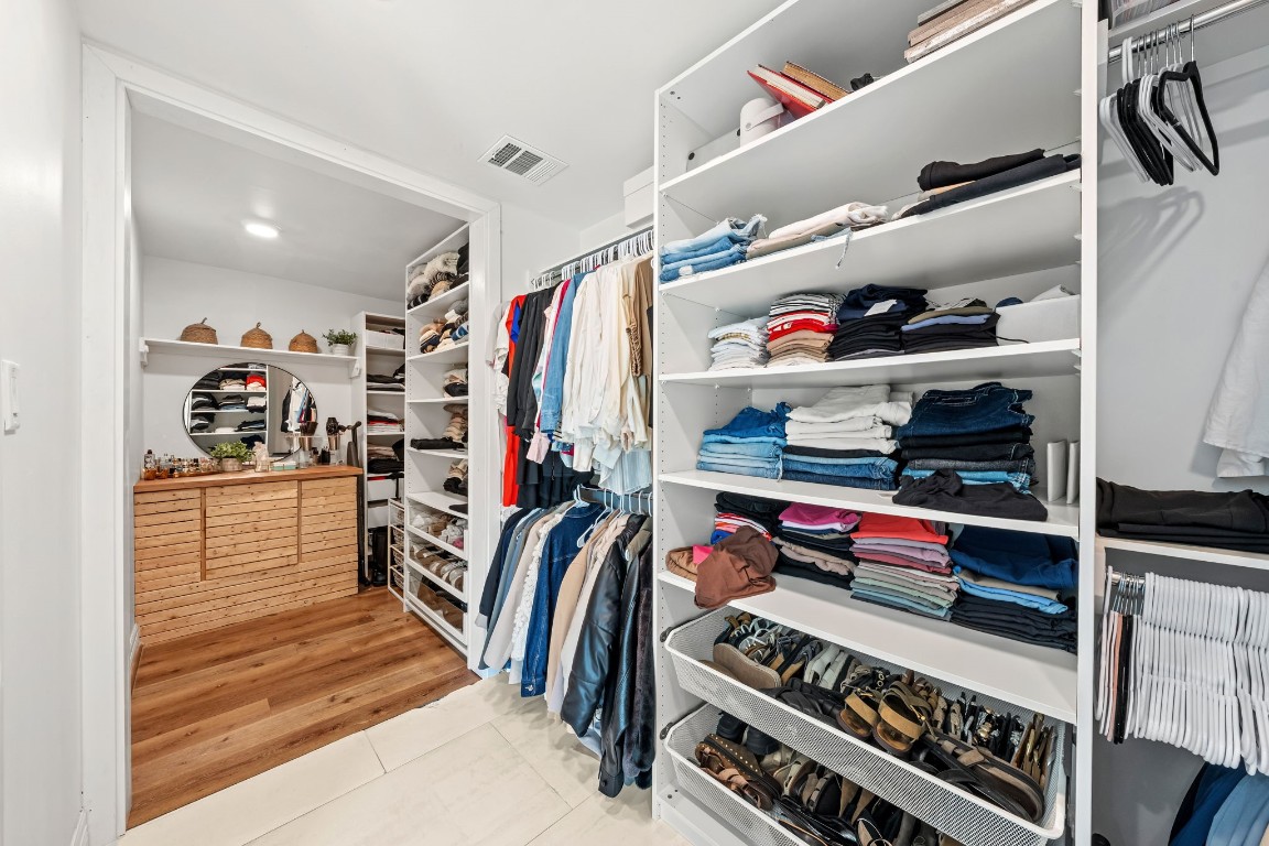 8800 Brae Acres Road Houston, TX 77074 - Photo 23 of 48 The walk-in closet is outfitted with a built-in wire organization system covering both walls — dedicated sections for hanging, folded items, and shoe storage at the base. Its natural divide creates two distinct areas for those sharing this large closet with someone else.