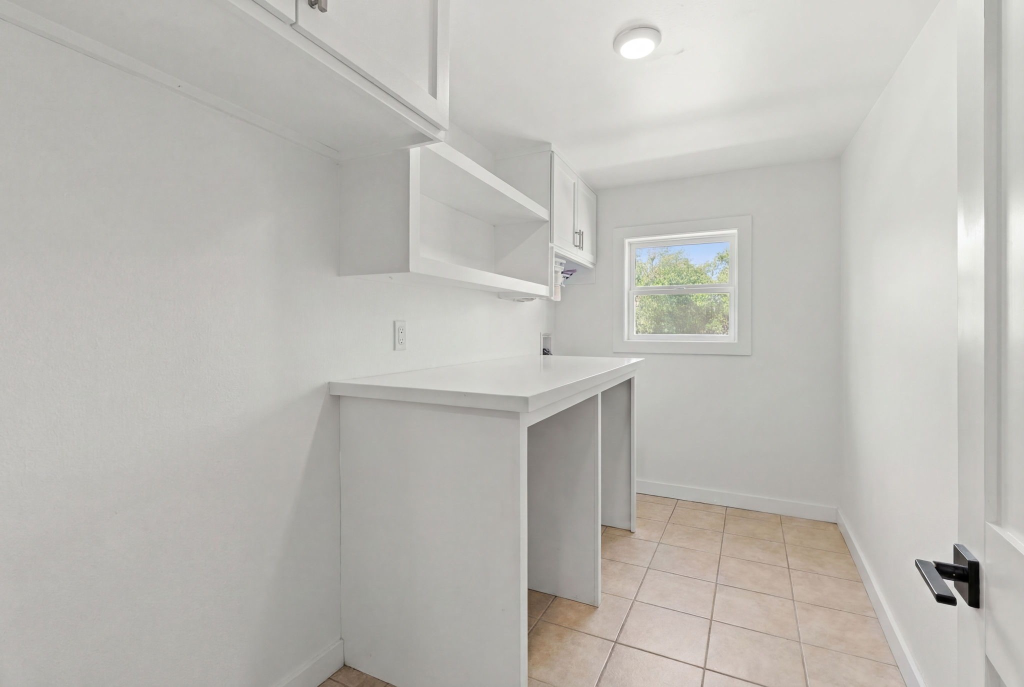 8800 Brae Acres Road Houston, TX 77074 - Photo 25 of 48 The utility room includes a full-size refrigerator position along the entry wall alongside upper cabinetry and shelving. This in home utility room provides ample floor area for side-by-side appliances and built-in upper storage for all your laundry needs.