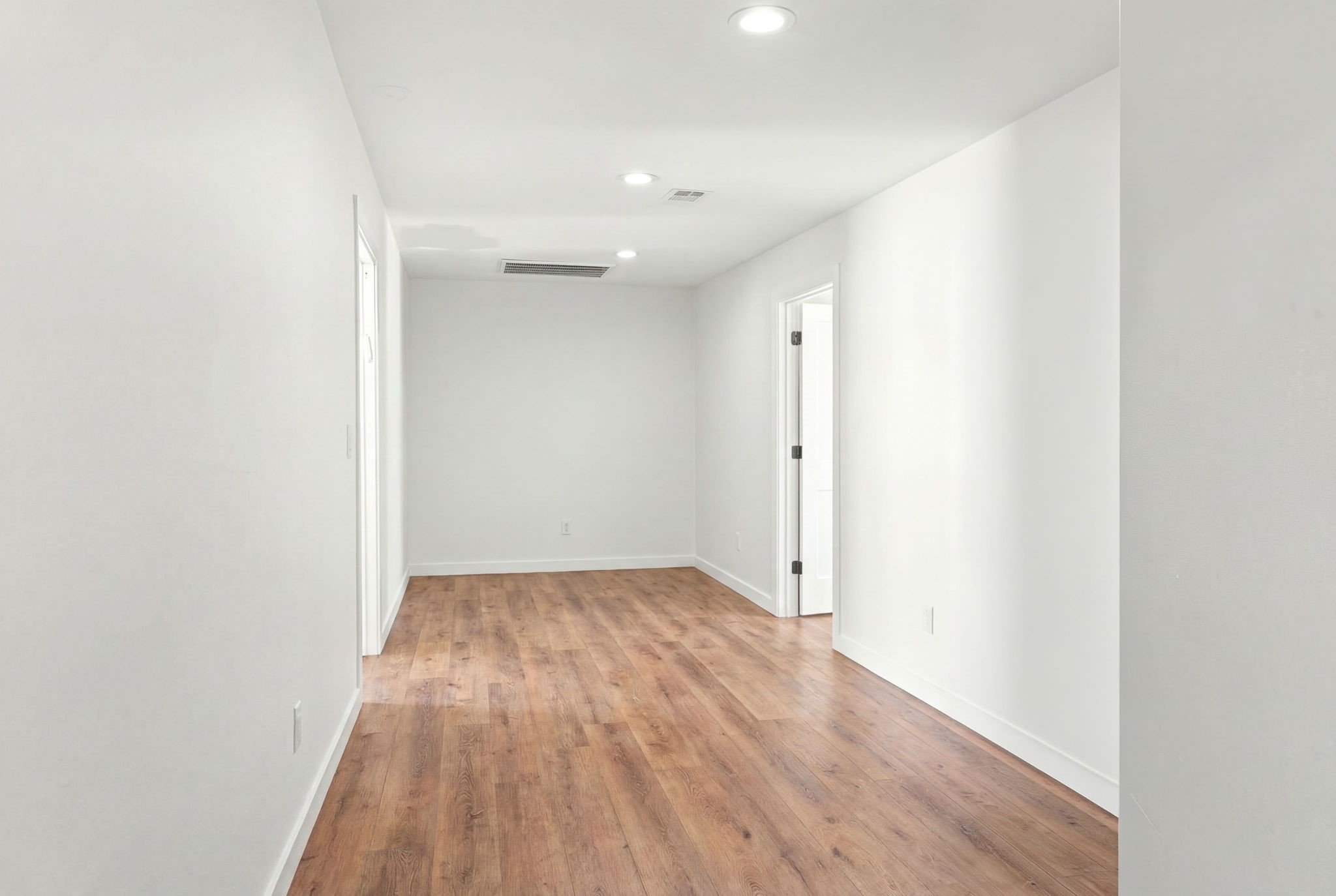 8800 Brae Acres Road Houston, TX 77074 - Photo 26 of 48 This corridor connects two secondary bedrooms directly to the game room and remainder of the home, with wide-plank vinyl plank floors running throughout while recessed lighting keeps the passage bright between rooms. This space additionally can double as a home office / study or den space.
