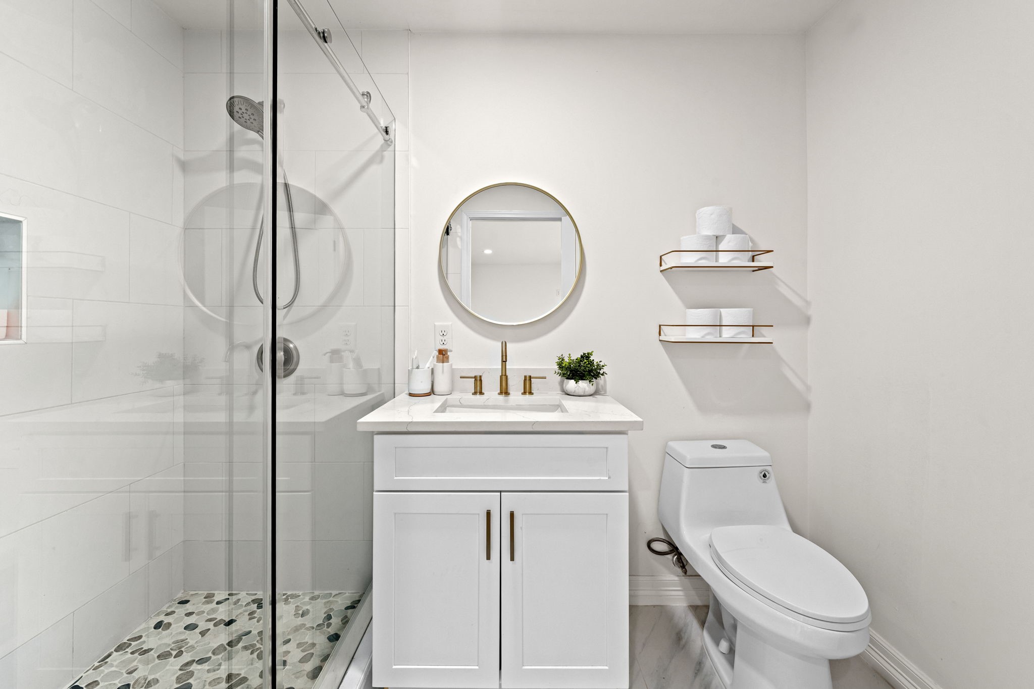 8800 Brae Acres Road Houston, TX 77074 - Photo 28 of 48 The bright and inviting en-suite bath features a glass enclosed walk-in shower, single vanity with brushed gold hardware, and bright lighting - a perfect retreat to get ready in.