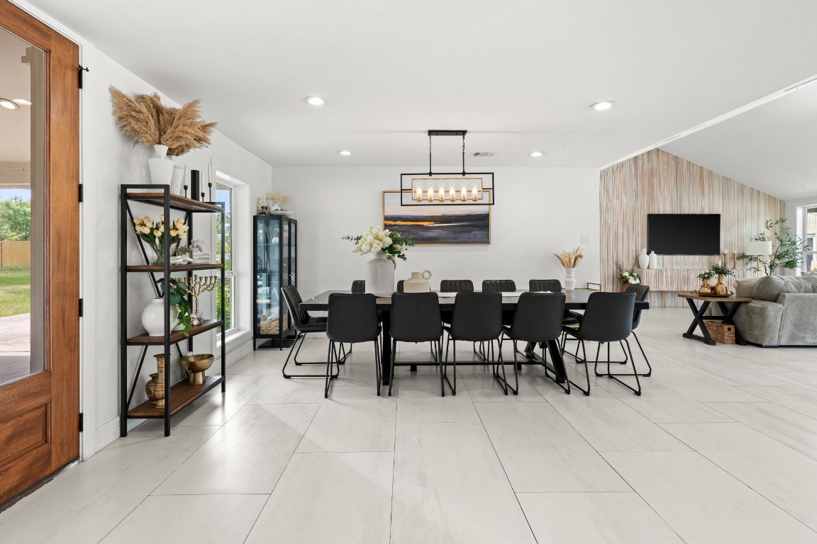 8800 Brae Acres Road Houston, TX 77074 - Photo 6 of 48 From this angle, the dining area sits in direct sightline of the wood double entry doors — the connection between arrival and gathering is immediate and intentional.