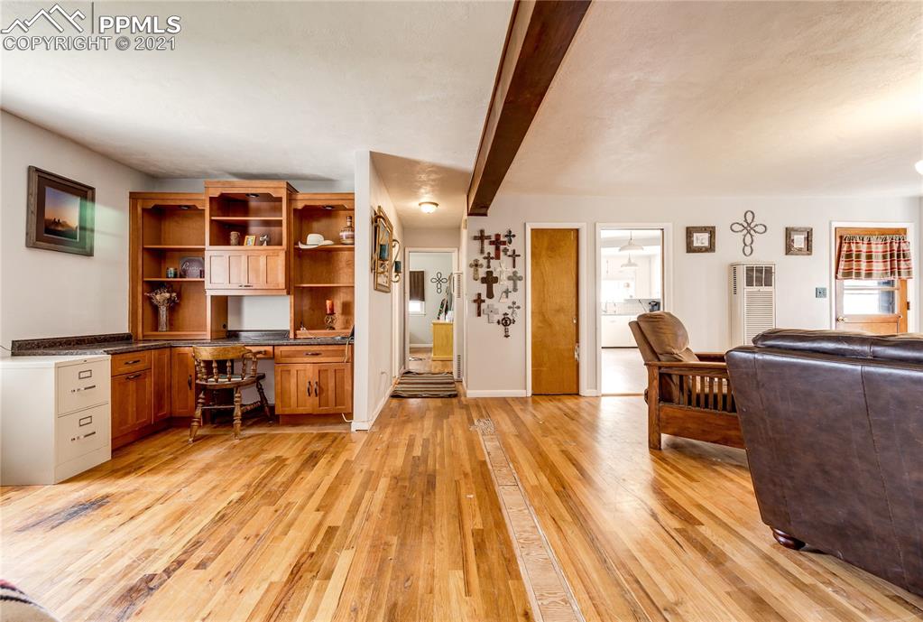 38810 Fossinger Road Rush, CO 80833 - Photo 11 of 35 a living room with furniture and a dining table with wooden floor