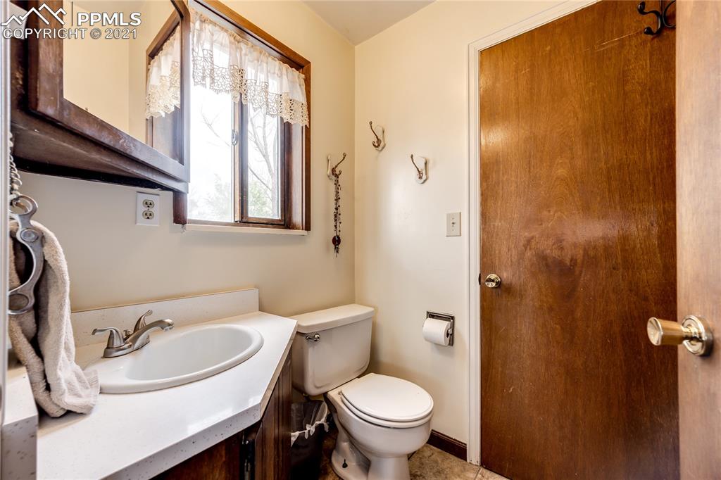 38810 Fossinger Road Rush, CO 80833 - Photo 20 of 35 a bathroom with a sink a toilet and a mirror