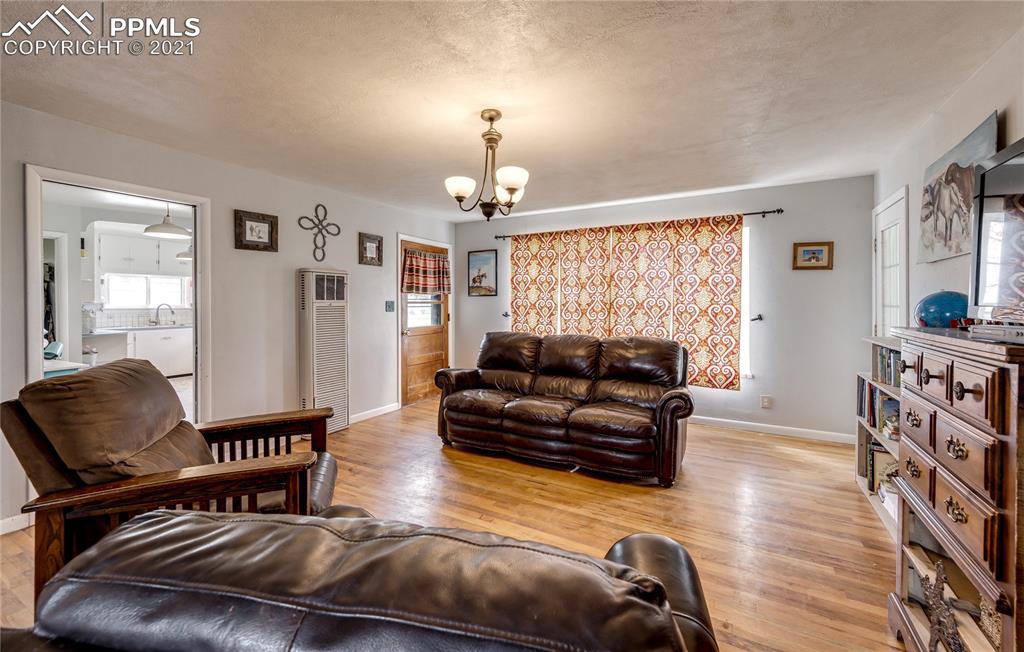38810 Fossinger Road Rush, CO 80833 - Photo 9 of 35 a living room with furniture and a chandelier
