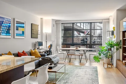 a living room with furniture and a potted plant