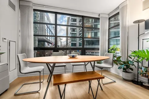 a room with furniture pool table and windows
