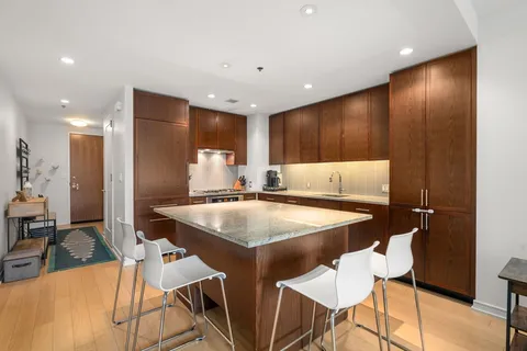a kitchen with a table chairs sink and cabinets