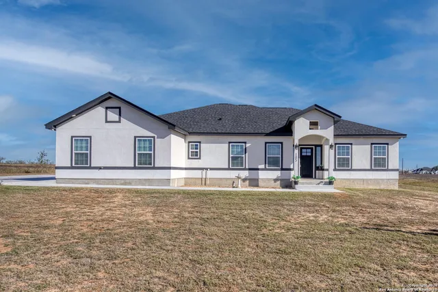 a front view of a house with a yard