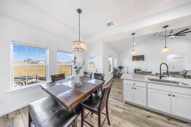 a view of a kitchen and dining table chairs in it