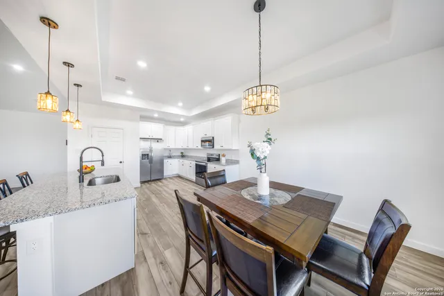 a view of a dining room with furniture and chandelier