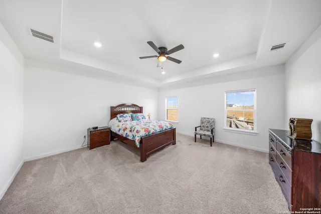 a bed room with furniture and a ceiling fan