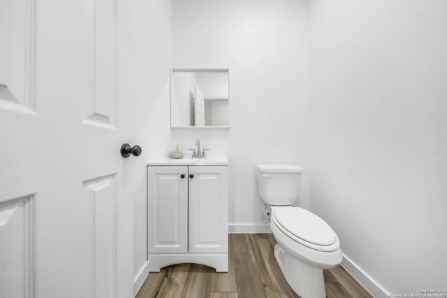 a white toilet sitting next to a bathroom sink