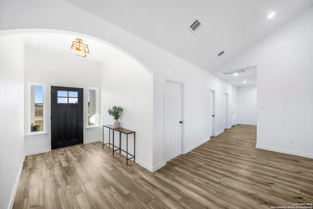 a view of a hallway view with wooden floor and staircase