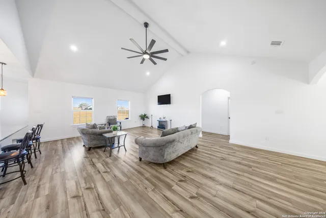 a living room with furniture and wooden floor