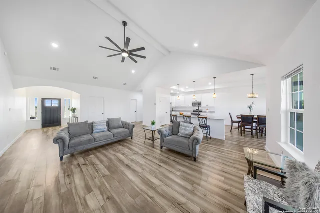 a living room with furniture and wooden floor