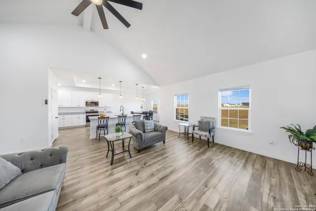a living room with furniture and a wooden floor