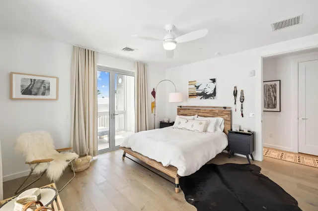 a bedroom with a bed and painting on the wall