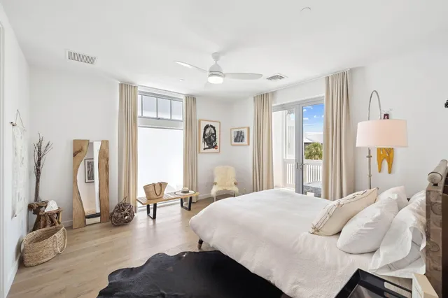 a bedroom with furniture and a large window