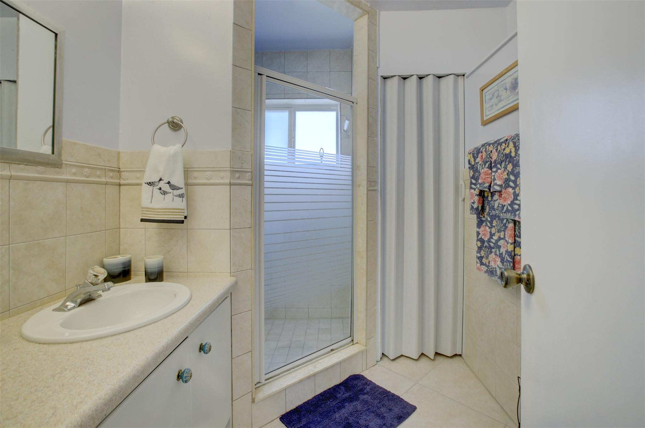 999 North Riverside Drive, Unit 11 Pompano Beach, FL 33062 - Photo 9 of 12 a bathroom with a sink and a mirror