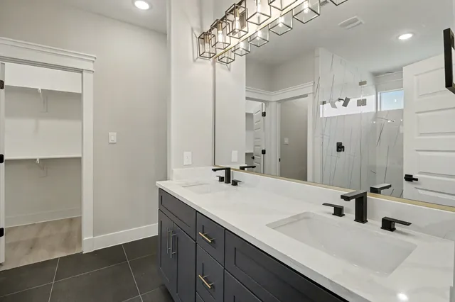 a bathroom with a sink a mirror and a shower