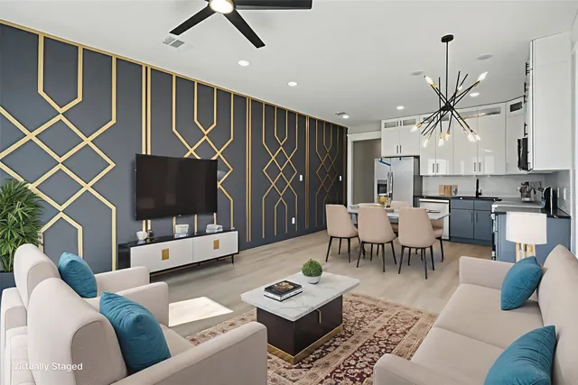 a living room with furniture a flat screen tv and a table