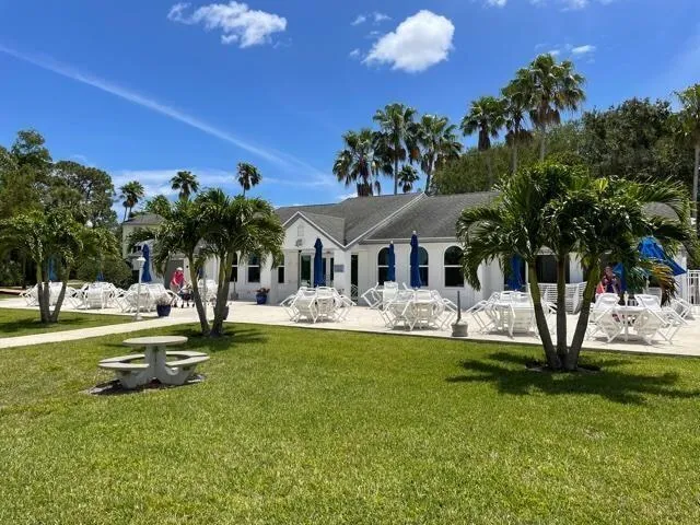 a view of a house with a backyard porch and sitting area
