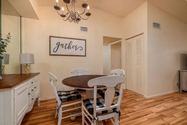 a view of a dining room with furniture and wooden floor