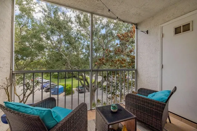 a balcony with wooden floor and outdoor seating
