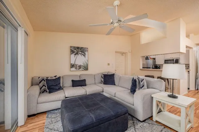 a living room with furniture and a lamp