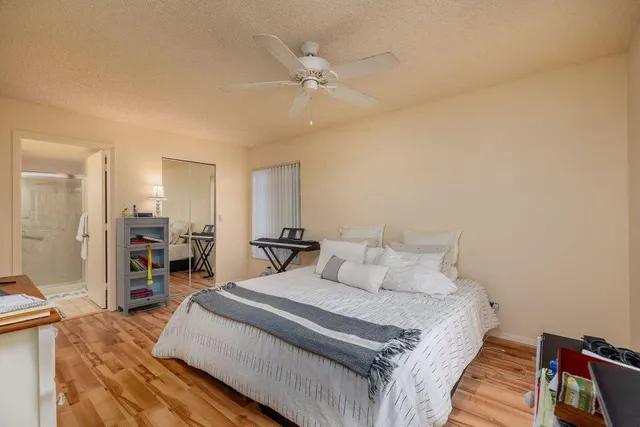 a bedroom with a large bed and a chandelier