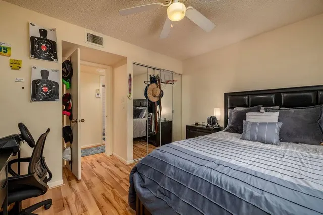 a bedroom with a bed and a chandelier