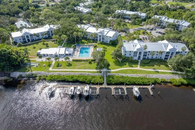 an aerial view of a house with a garden and lake view