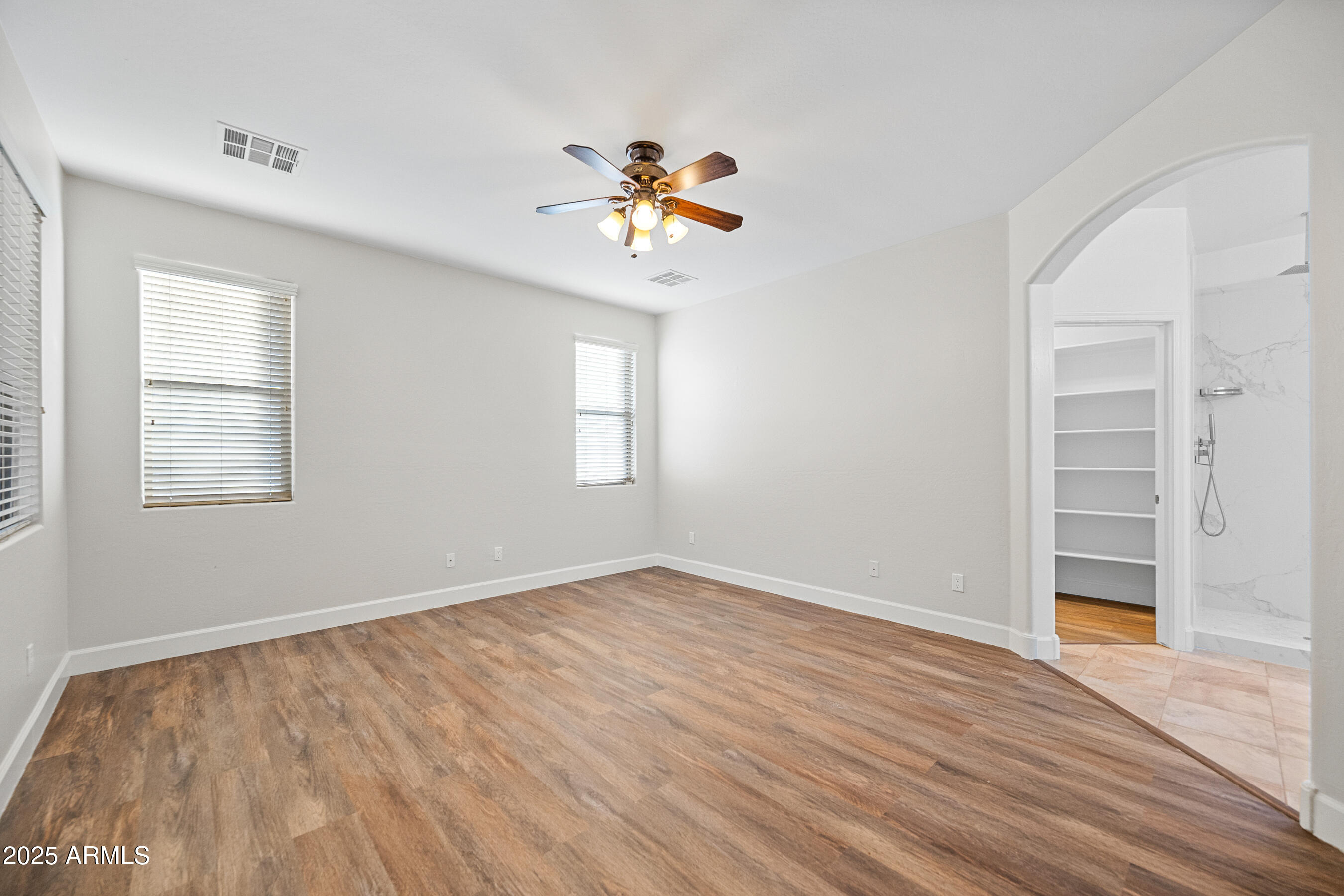 10805 West Woodland Avenue Avondale, AZ 85323 - Photo 14 of 25 wooden floor in an empty room with a window