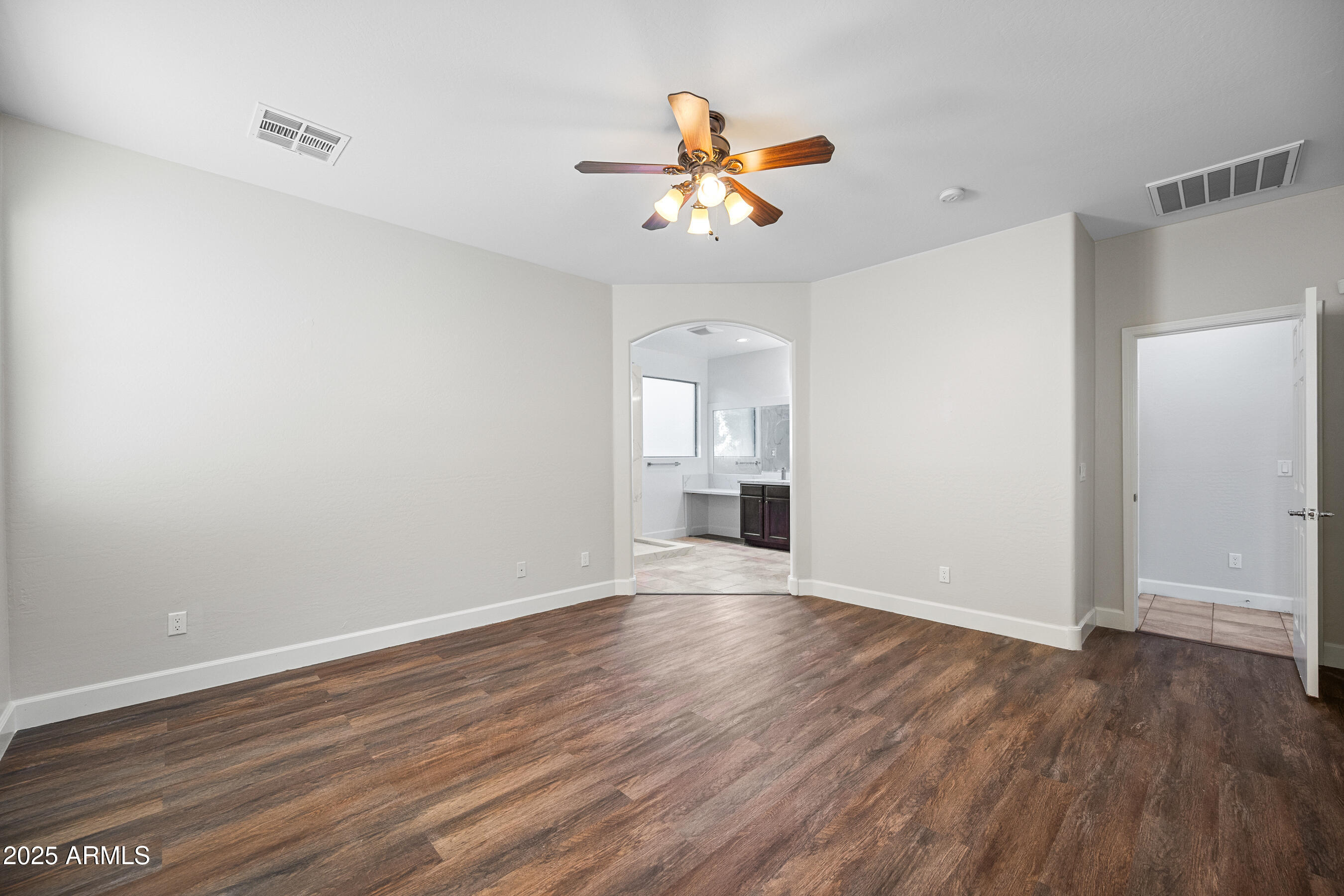 10805 West Woodland Avenue Avondale, AZ 85323 - Photo 15 of 25 wooden floor in an empty room with a window