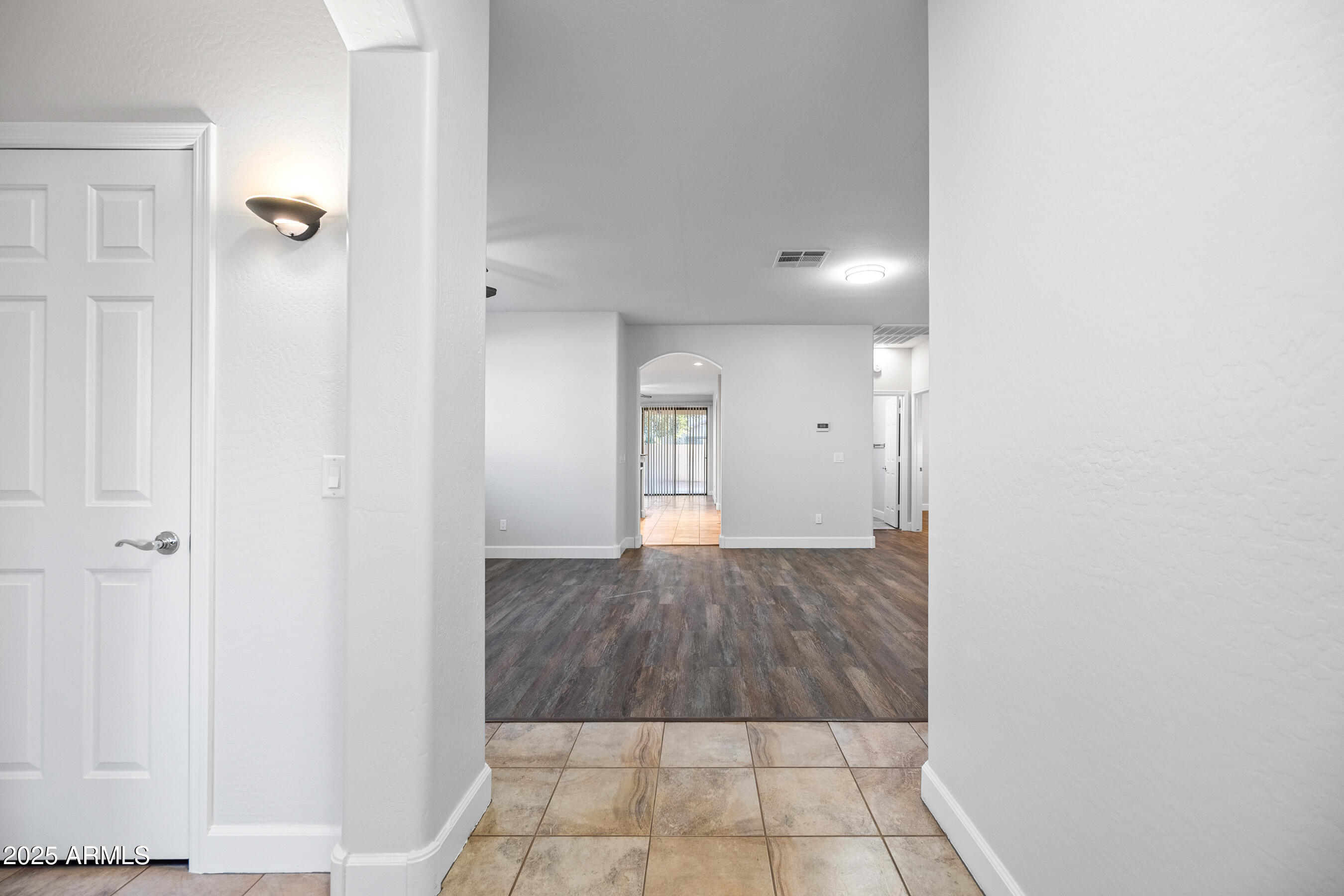 10805 West Woodland Avenue Avondale, AZ 85323 - Photo 2 of 25 a view of a hallway with wooden floor and staircase