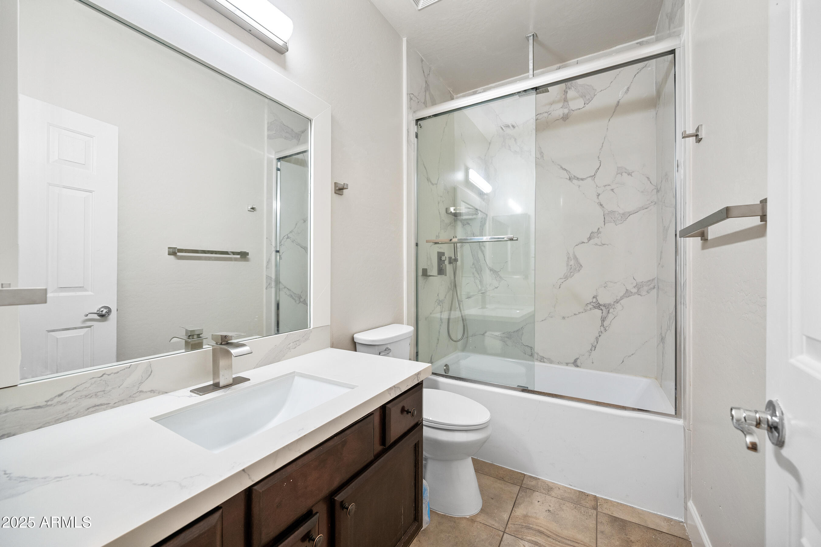 10805 West Woodland Avenue Avondale, AZ 85323 - Photo 21 of 25 a bathroom with a sink a toilet and shower