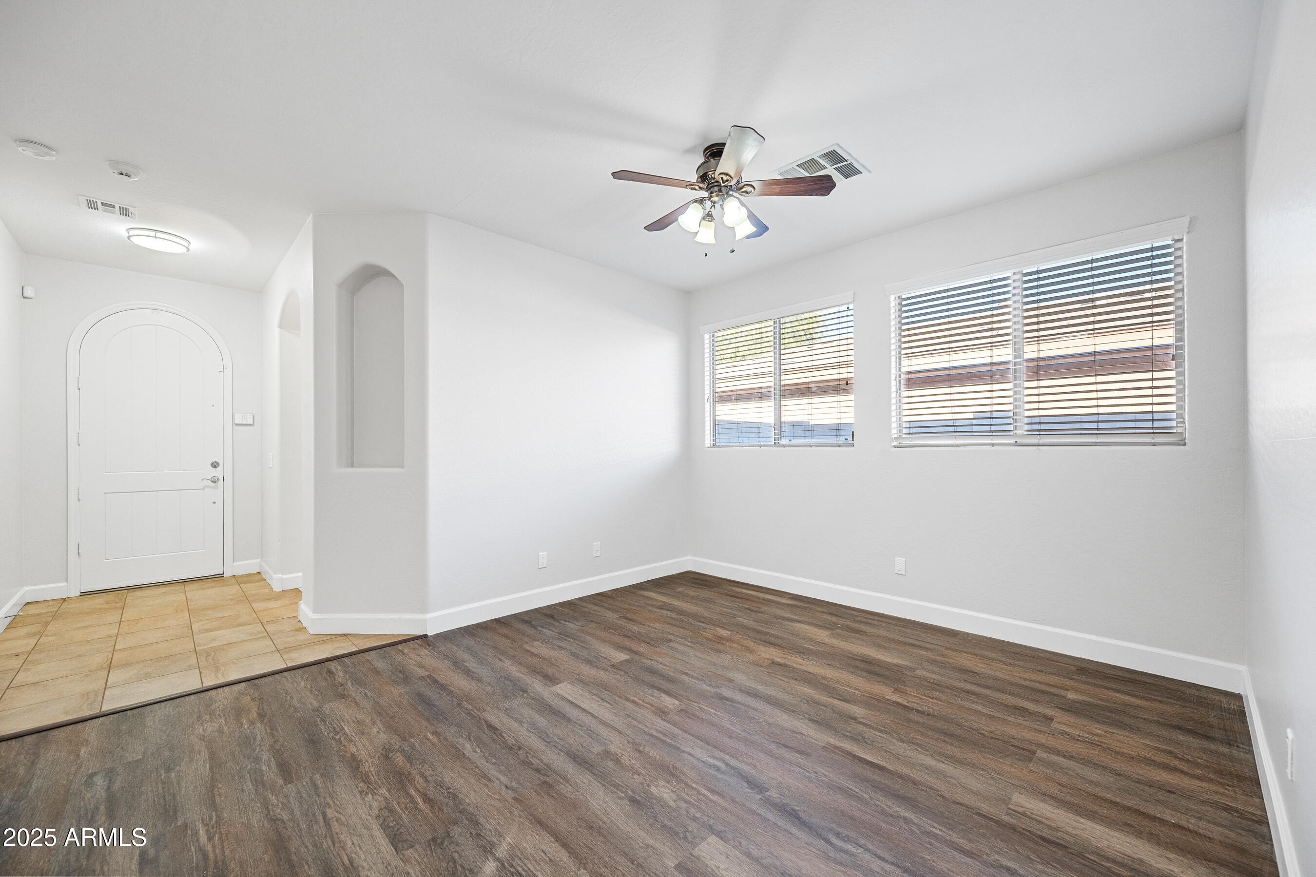 10805 West Woodland Avenue Avondale, AZ 85323 - Photo 4 of 25 a view of empty room with wooden floor and fan