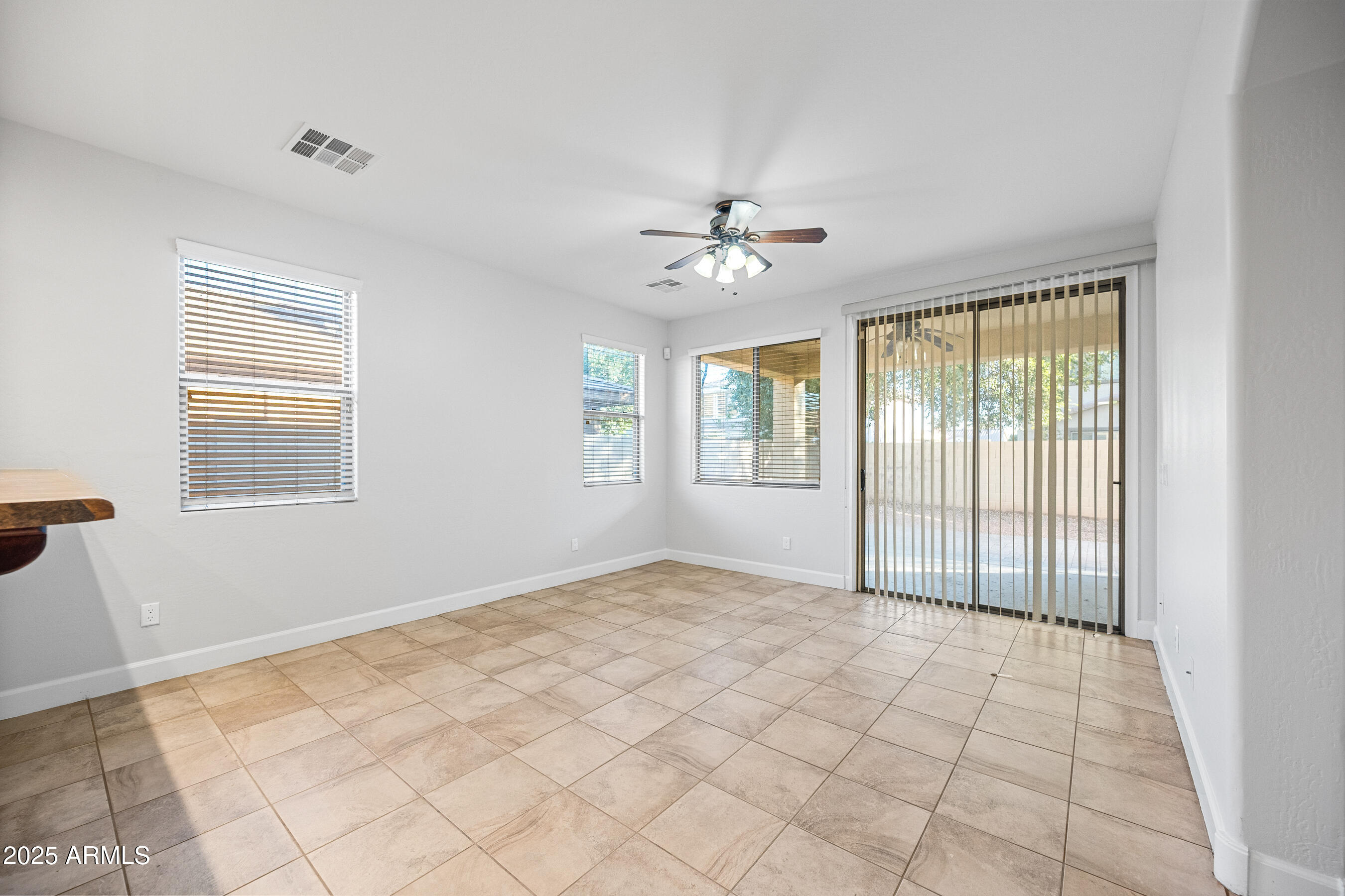10805 West Woodland Avenue Avondale, AZ 85323 - Photo 7 of 25 a view of an empty room with a window