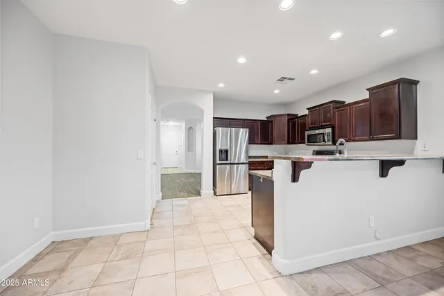 a kitchen with stainless steel appliances a refrigerator sink and microwave
