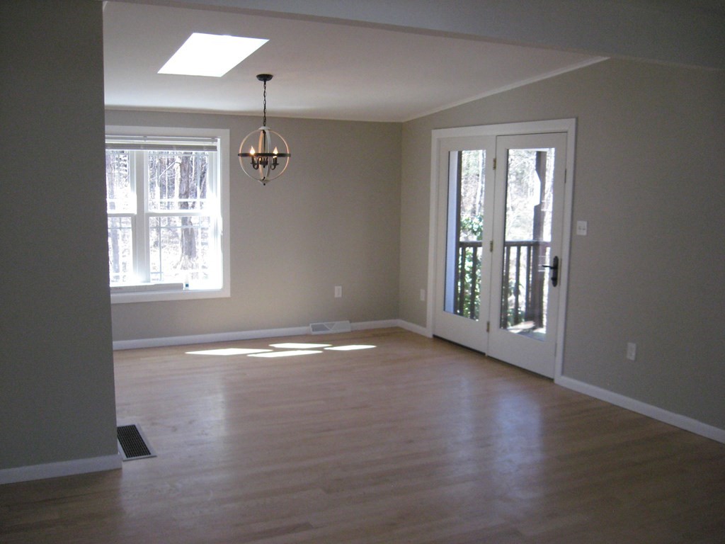 5 Old Amherst Road, Unit 5B Belchertown, MA 01007 - Photo 13 of 37 an empty room with wooden floor and windows
