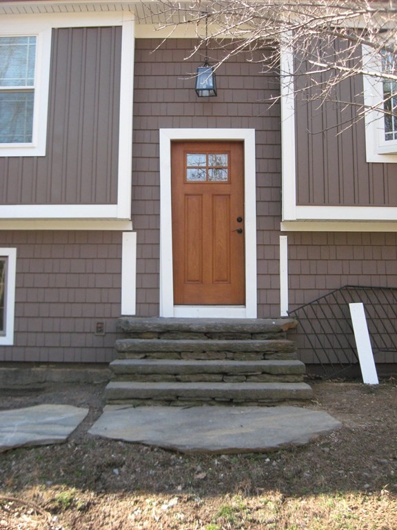 5 Old Amherst Road, Unit 5B Belchertown, MA 01007 - Photo 3 of 37 a front view of a house with a garage