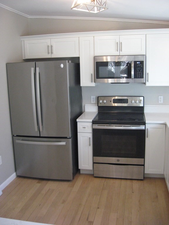 5 Old Amherst Road, Unit 5B Belchertown, MA 01007 - Photo 8 of 37 a stove top oven sitting inside of a kitchen