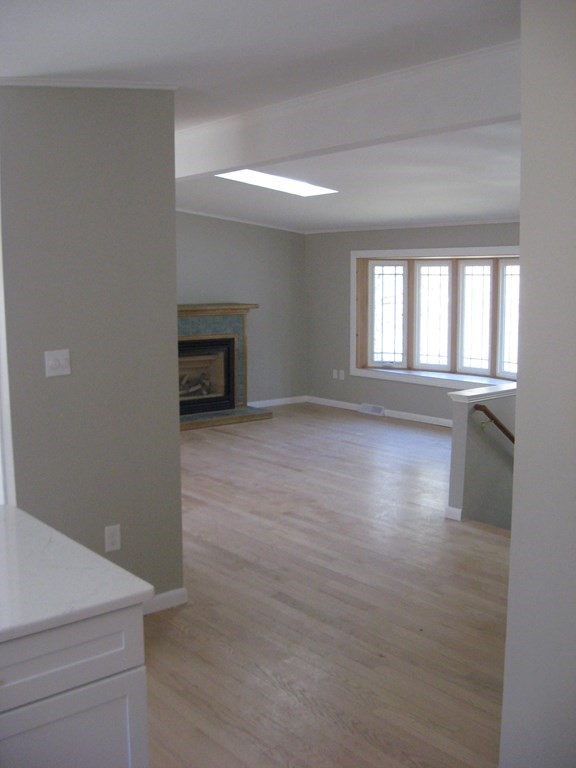 5 Old Amherst Road, Unit 5B Belchertown, MA 01007 - Photo 10 of 37 an empty room with windows and fireplace