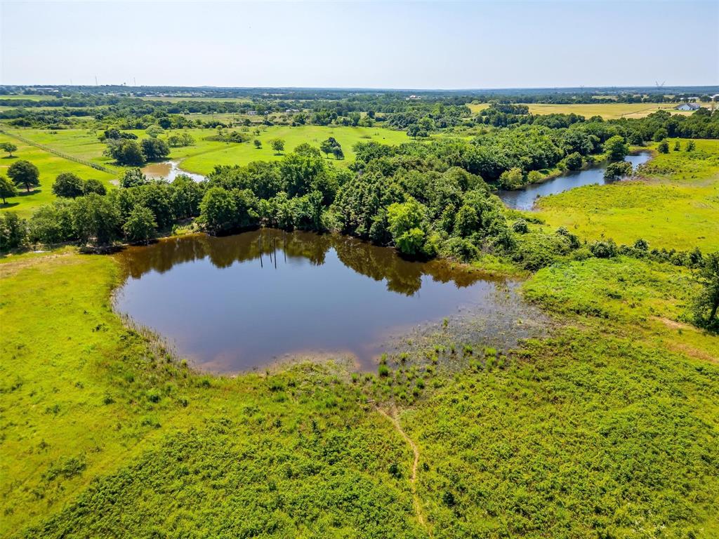 210 Trails End Poolville, TX 76487 - Photo 6 of 25 a view of a lake with a yard