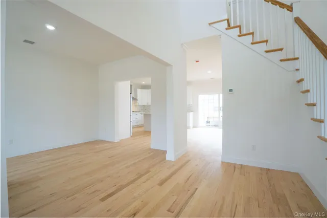 a view of entryway with wooden floor and stairs