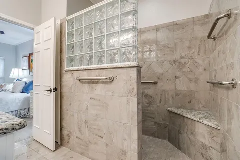a view of a bathroom with a window and a shower