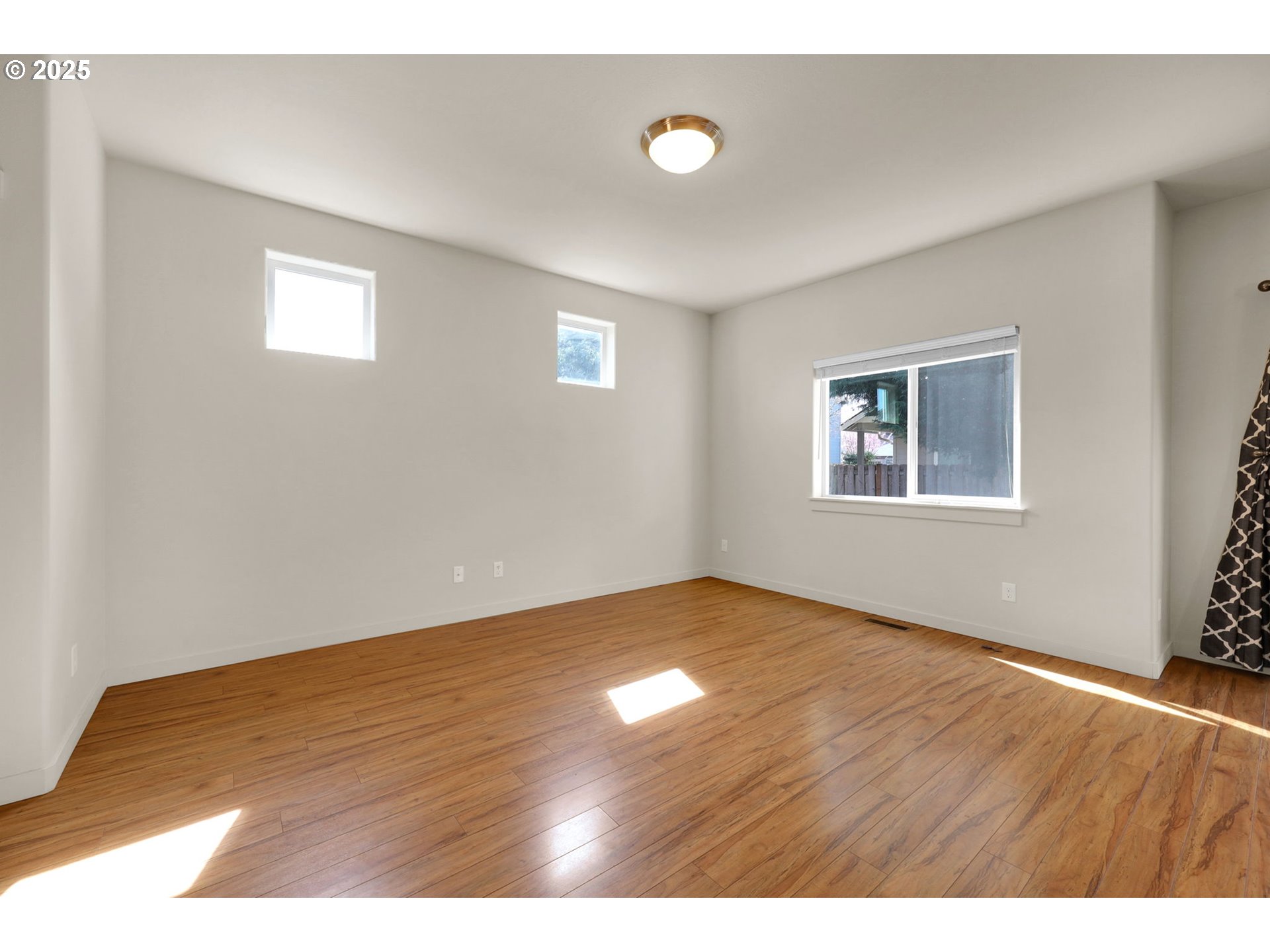 490 Raber Road Eugene, OR 97402 - Photo 11 of 37 a view of an empty room with wooden floor and a window