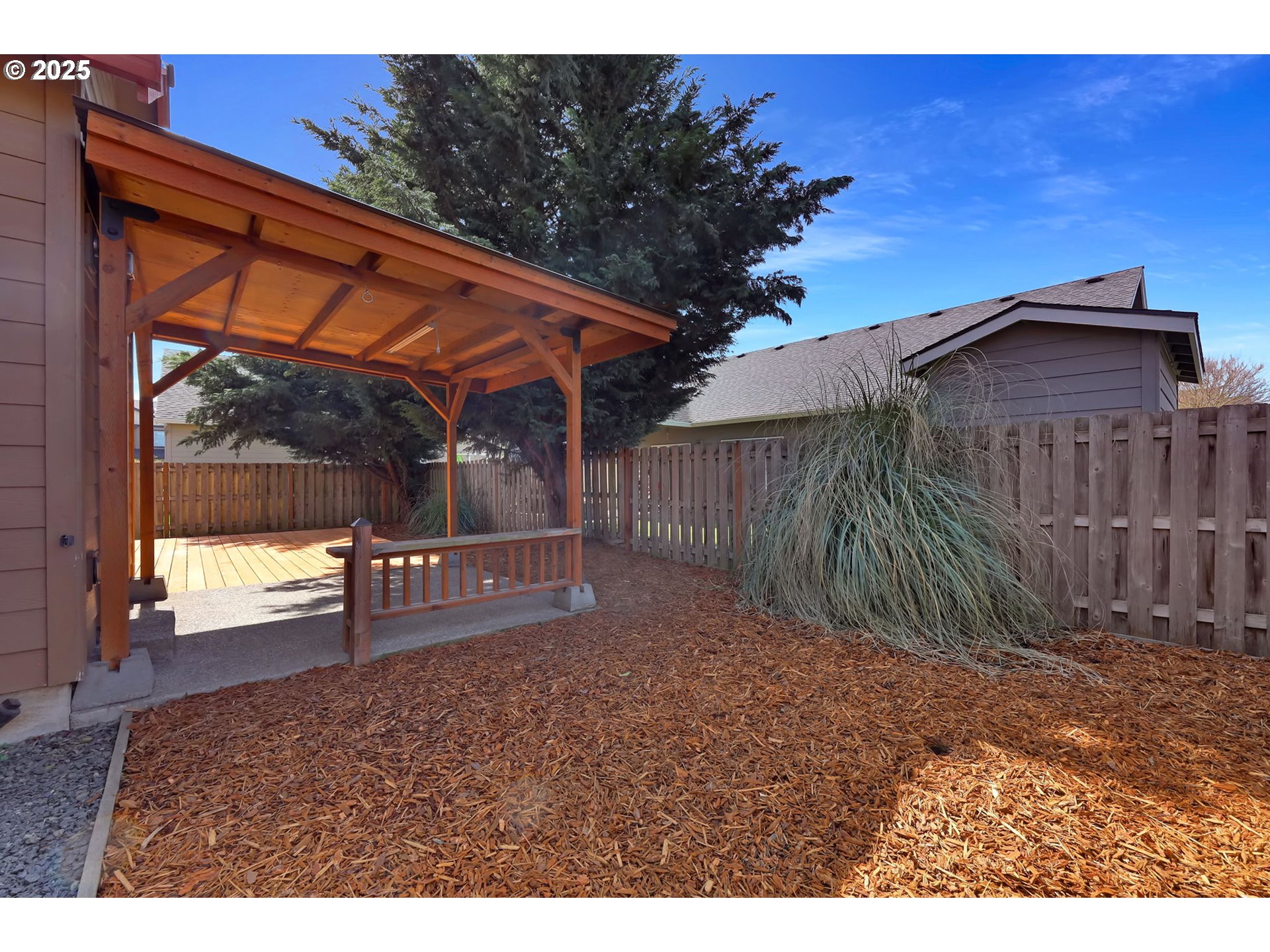 490 Raber Road Eugene, OR 97402 - Photo 34 of 37 a view of a backyard with a small cabin and wooden fence